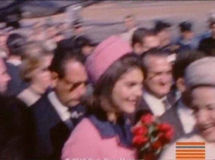 Jacqueline Kennedy follows, carrying a bouquet of red roses given to her by local officials.<br/><br/>She's walking alongside Lyndon Baines Johnson, the vice president at the time. A smiling Lady Bird Johnson appears briefly. She's followed by Governor John Connally, who was wounded in the shooting later in the day.