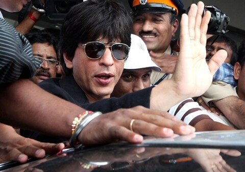 <span class="lh16 fa fs12 fb"><strong>Happy to be back:</strong> Bollywood superstar Shah Rukh Khan is back in Mumbai after a rocky visit to America where he was held up for questioning at Newark Airport, much to the chagrin of his fans the world over. As he got into his car at the airport, Shah Rukh waved, smiled and gave his trademark salaam to his fans. (AFP) </span>