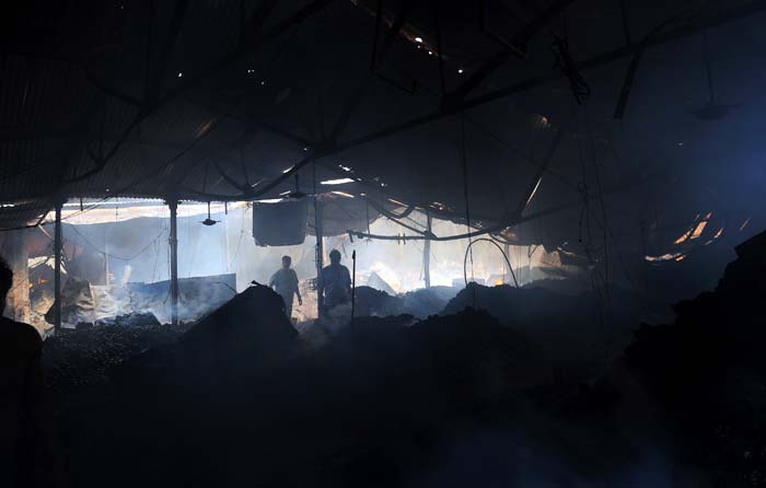 Fire fighters look on as the fire subsided