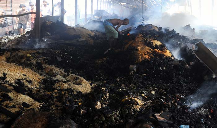 A man clearing the damage caused by the Hatibagan fire.