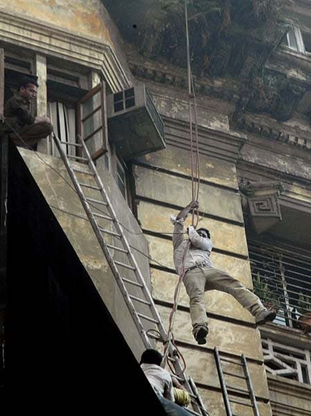 Seen here, rescue workers help trapped people escape from the building. (AP Photo)