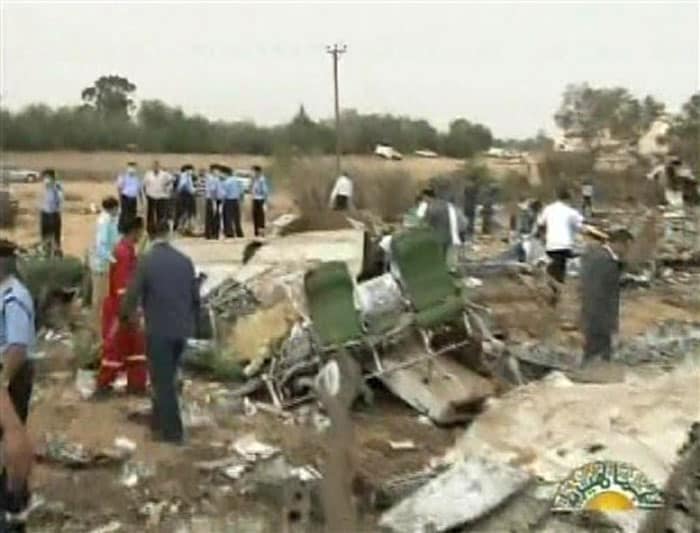 Seen here, police and workers go through the wreckage. (AP Image)