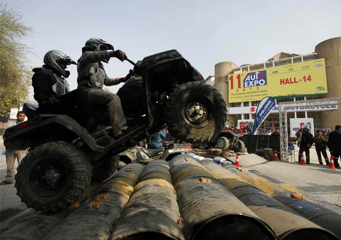 A Polaris ATV off-road vehicle is tested on a off-road track at the Auto Expo 2012.