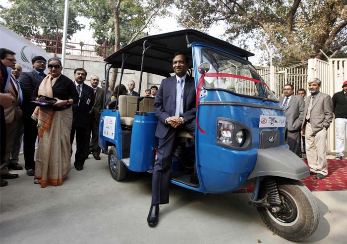 Mahindra & Mahindra's automotive and farm equipment President Pawan Goenka poses in a HyAlfa at its launch at the Auto Expo 2012.