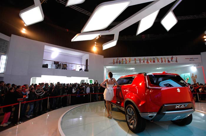 A model poses with a Maruti Suzuki XA- Alpha concept car at the Auto Expo in New Delhi.