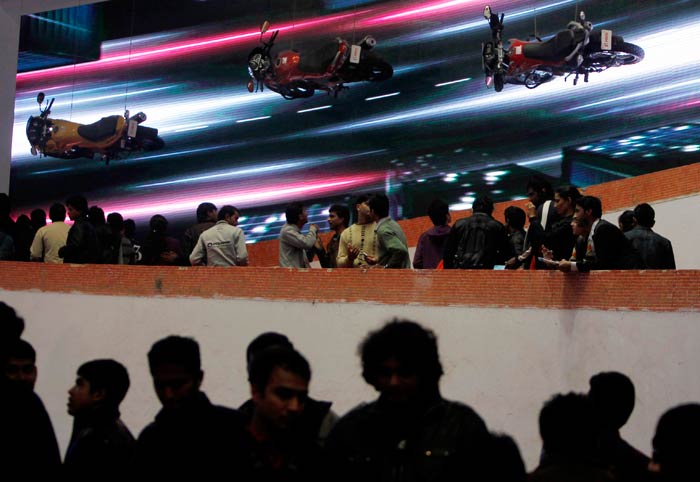 Crowds gather near the pavilion of a bike company at Auto Expo 2012.