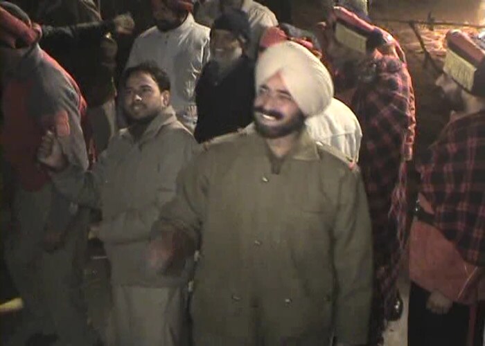 A police official is all smiles as he watches over the celebrations.(NDTV Photo)