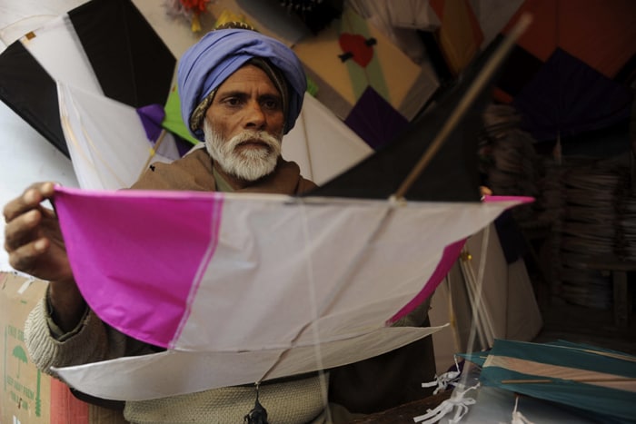 In this picture, a kitemaker prepares kites at his workshop in Amritsar. (AFP Photo)