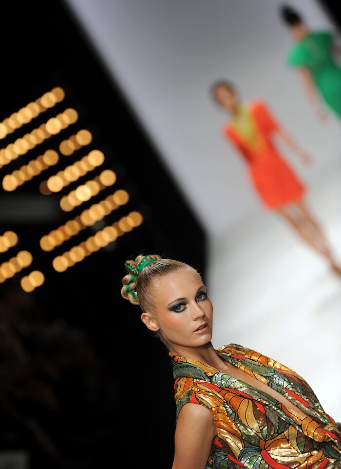 Models walk down the catwalk wearing clothes by Issa London for the Spring/Summer 2010 collection on the third day of the London Fashion Week, in central London, on September 20, 2009. AFP PHOTO/Ben Stansall