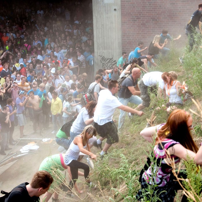 This picture shows how the revellers rushed up a hill after panic broke out during the Love Parade. (AFP Photo).