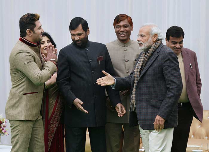 Prime Minister Narendra Modi, along with Transport Minister Nitin Gadkari, celebrates Makar Sankranti with Union minister Ram Vilas Paswan at his residence in New Delhi. (Press Trust of India)