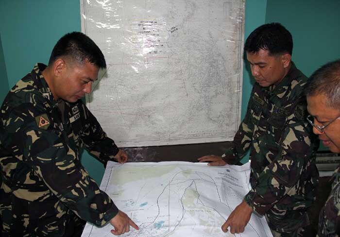 This handout photo released by the Philippine Military Western Command shows personnel planning search and rescue operations for the flight.