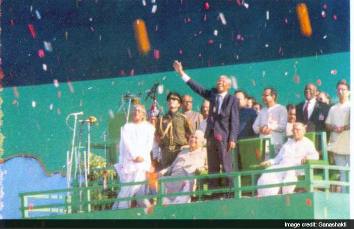 Mr. Mandela waves as he is given a rousing welcome at the Eden Gardens.