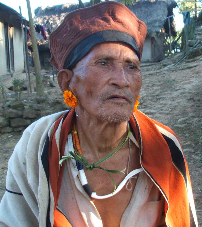 A village elder of Phoklong village wearing marigold flowers as ear rings. (Photo courtesy: Kishalay Bhattacharjee)