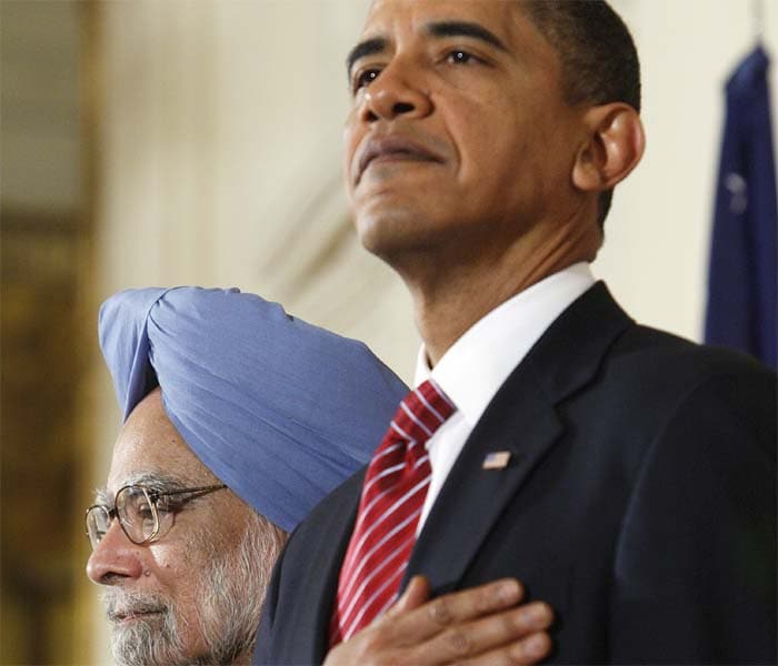 US President Barack Obama and Prime Minister Manmohan Singh stand for the playing of the national anthems during the state arrival ceremony. (AP Photo)