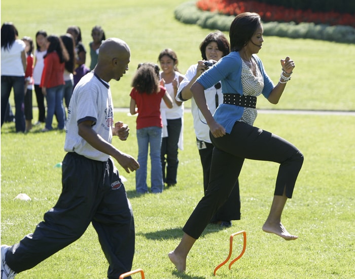 Michelle Obama was hosting a &quot;healthy kids fair&quot; on the South Lawn of the White House, inviting around 100 children and parents from local elementary schools, for an afternoon of fun-filled physical activity and encouraging children to eat better. She also participated in an obstacle course, and whizzed barefoot through a series of hurdles and back to the starting line. (AP Photo)