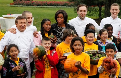 Michelle Obama later posed for a group photo with the harvest team, and told the media that the harvest would be used by various food pantries around the capital. (AP Photo)