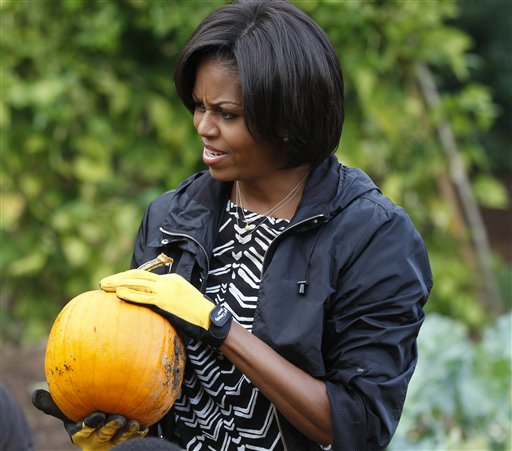 "You guys have witnessed the first White House pumpkins," the first lady told the children as they loaded up wheelbarrows and weighed in their haul. (AP Photo)