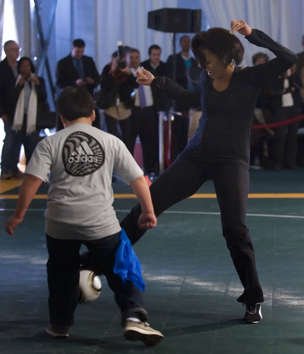 US First lady Michelle Obama kicked soccer balls with youngsters to encourage them to get the recommended hour of daily exercise as she promoted her campaign against childhood obesity. (AFP Image)