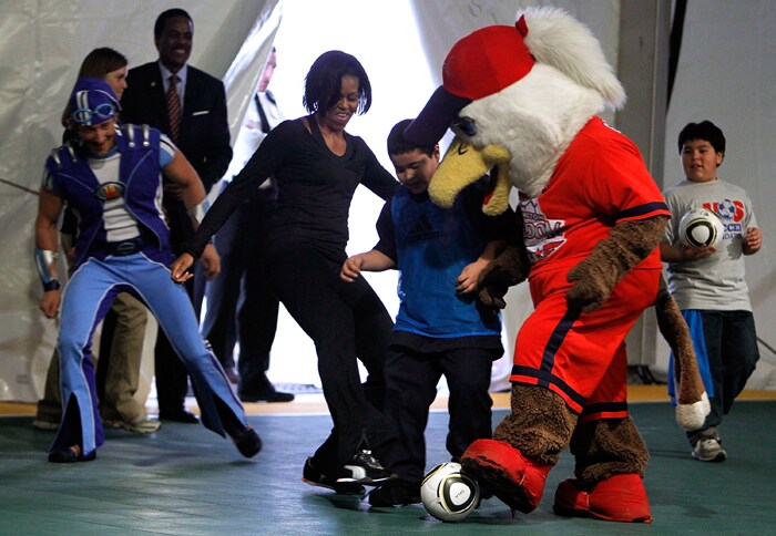 Michelle Obama kicks the ball at a soccer clinic in Washington to highlight the 'Let's Move!' campaign and the importance of children getting 60 minutes of active play each day. (AFP Image)