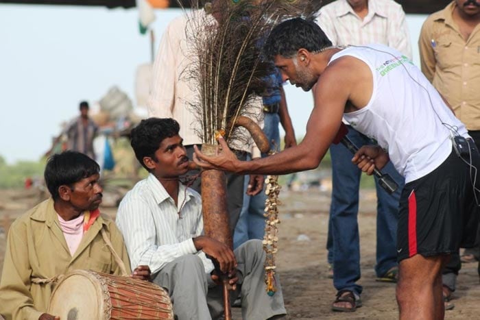 Milind Soman talks to the tribals near the Vulture feeding ground.