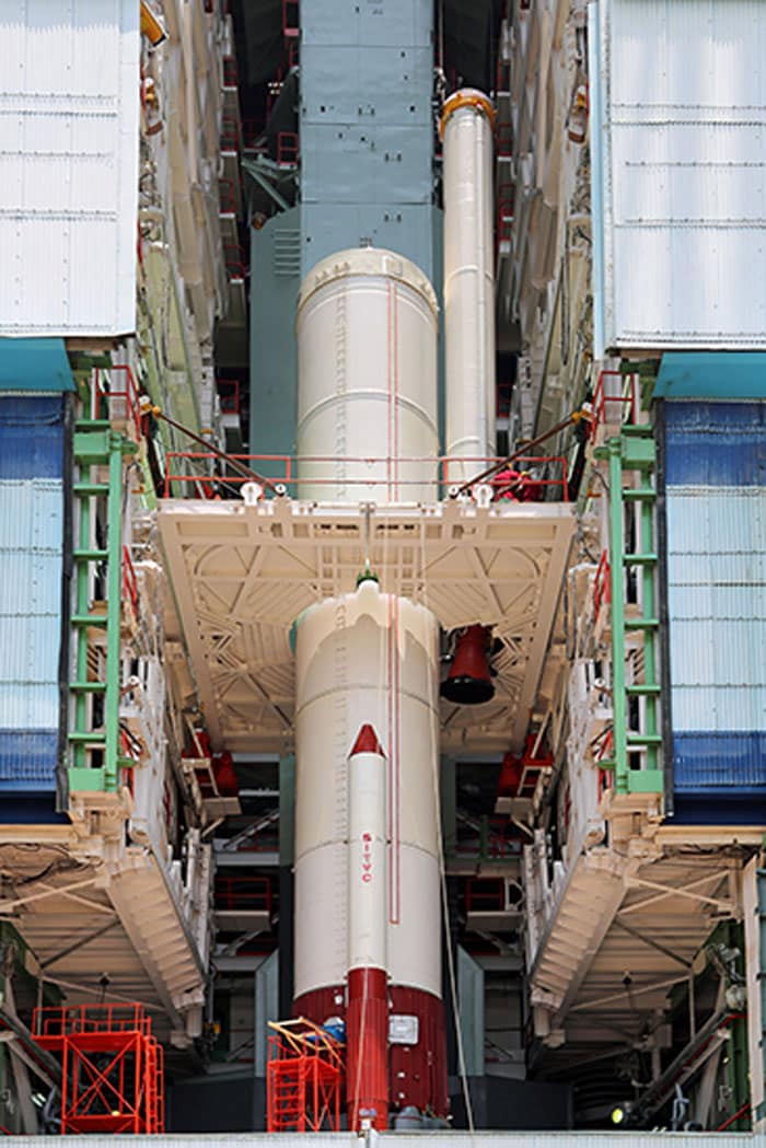 One of the strap-ons of PSLV-C25 being lowered to its position during vehicle integration.<br><br>Photo Credit: ISRO