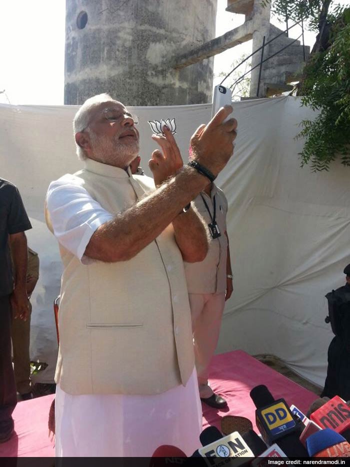 Narendra Modi taking a selfie after casting his vote during the national election.