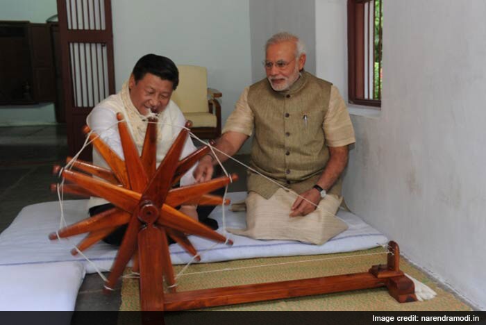 PM Modi introducing Chinese President Xi Jinping to the charkha at Mahatma Gandhi's Sabarmati Ashram in Gujarat.