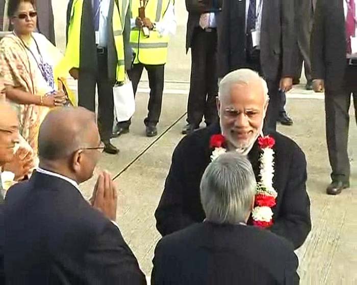 A garland welcome for Prime Minister Narendra Modi where he is received by a delegation led by British High Commissioner to India James Bevan and British parliamentarian Hugo Swire.