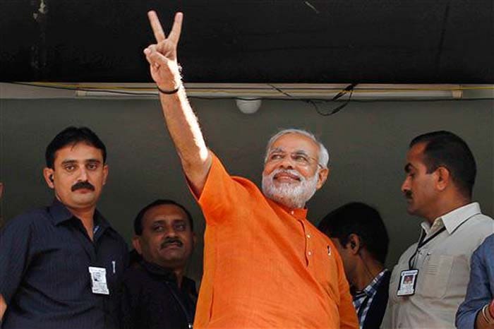 Dressed in saffron, Gujarat Chief Minister Narendra Modi has cast his vote at the Ranip polling booth in Ahmedabad amid much cheering by a huge crowd of supporters gathered.