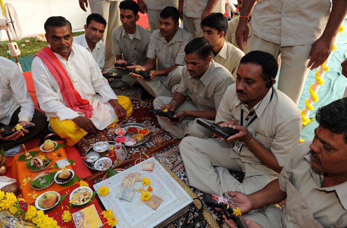 Security officials engaged in Narendra Modi's security participate in a <em>Shastra Puja. </em>The deities at this ceremony: machine guns, AK series rifles, swords, axes. Even a primitive club or two. (AFP Photo)