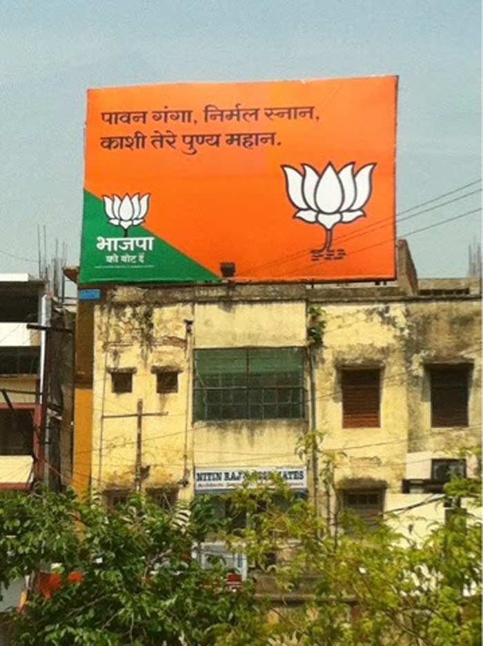 Varanasi: Changing posters of Modi...