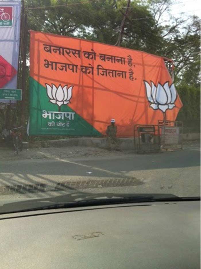 Varanasi: Changing posters of Modi...