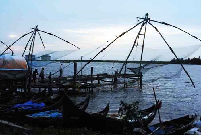 <b>Troubled Waters: </b> Unaccompanied boats stand at the edge as clouds hover above. The monsoon makes it difficult for boatmen to step into the water due to fears of capsizing. (Photo: Ketki Angre)