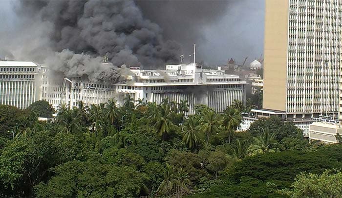 Smoke from the burning Mantralaya building, which houses the Maharashtra state secretariat, is pictured moving past the Mumbai skyline. (Photo courtesy: AFP)