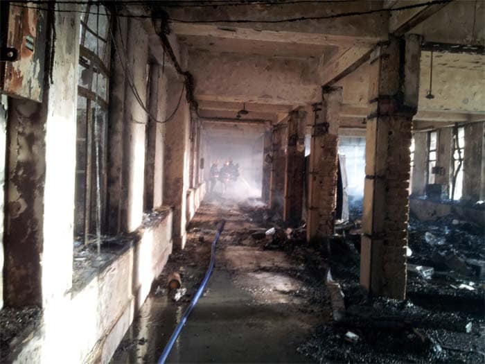 An exclusive picture of the damaged floor at the Maharashtra Mantralaya. Firefighters are seen spraying water to douse the fire. (NDTV picture)