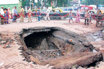 On September 16, 2008, an eight feet deep crater was detected at the Jacob Circle near Mahalaxmi. The reason for the same was a leakage in the main sewage line which in turn led to the weakening of the road surface.<br><br>Three persons were killed and two injured in the incident. (Picture: Mid-Day.com)