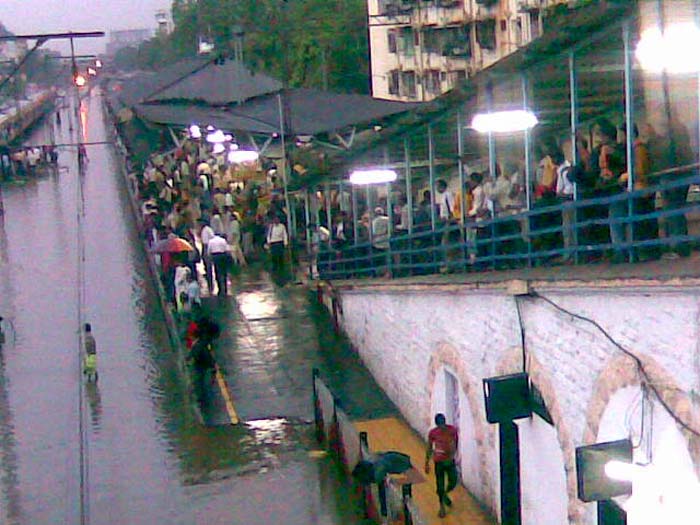 In this pic, people wait for a train to arrive at a flooded railway station in Mumbai. This image was shared by Sunny.