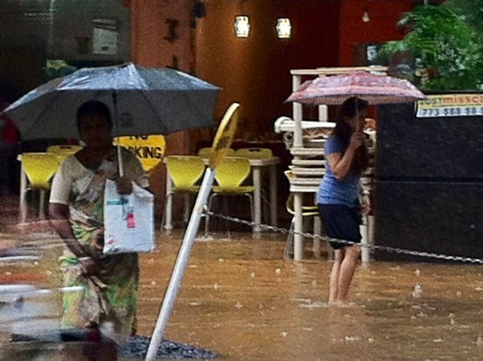 Mumbai's Western suburbs received light showers today after heavy rainfall over the weekend. 
<br><br>Seen here, residents of Kandivali wade through ankle-deep water on Sunday.