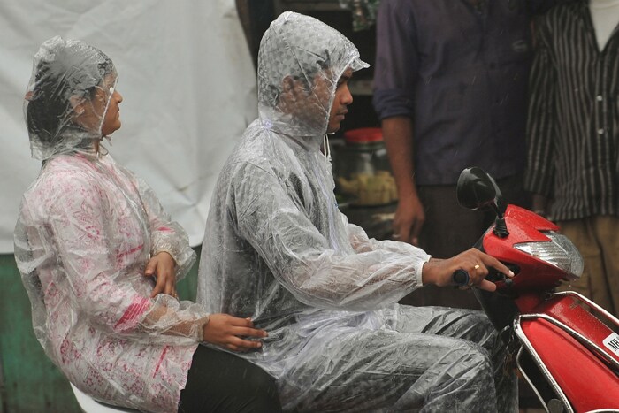 Mumbai's old menace has once again started to haunt the city. Torrential rain lashed the city on Wednesday virtually bringing it to a grinding halt.<br><br>Trains and flight schedules have been disrupted and traffic has been paralyzed owing to strong winds and fluctuating visibility. However, the city's subways are not shut.<br><br>The city has been experiencing a heavy downpour since Tuesday night and the BMC has issued warnings of high tide as well. (AFP Photo)