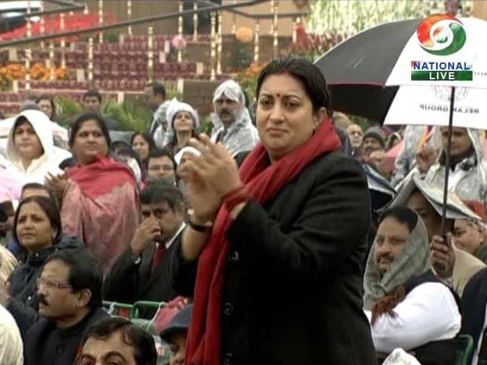 As the first of the all-women regiments march by, HRD Minister Smriti Irani cheers them on.