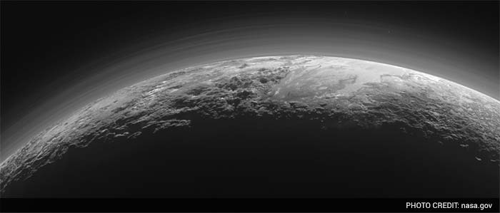 Just 15 minutes after its closest approach to Pluto on July 14, 2015, NASA's New Horizons spacecraft looked back toward the sun and captured this near-sunset view of the rugged, icy mountains and flat ice plains extending to Pluto's horizon.(NASA/JHUAPL/SwRI)