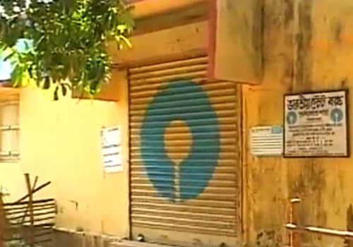 A State Bank of India branch with its shutters down stands testimony to the brutal attack that took place across the road at Sankrail Police Station, killing Dibakar Bhattacharya and leading to Dutta's kidnap. The bank was attacked minutes ago by the same group of Naxals who decamped with Rs nine lakh in cash. (NDTV Photo)