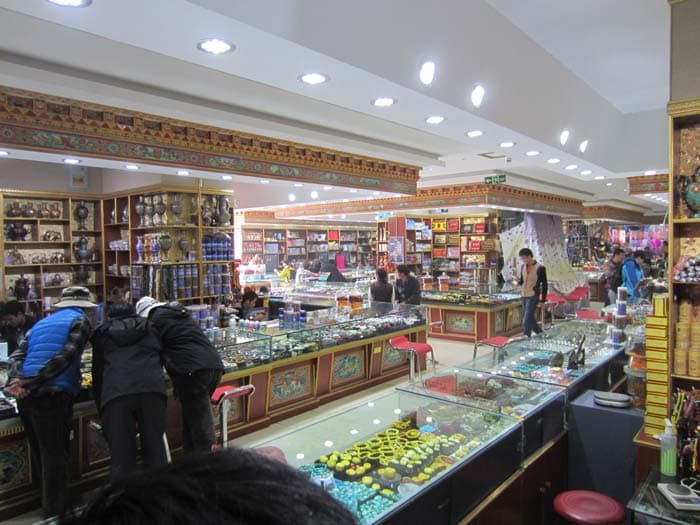 A shopping complex in Front yard of Jokhang Temple. Tourists buy souvenirs here, but the prices are steep like any tourist place. Different types of semi-precious stones, prayer beads, statues, even tea kettles can be bought here.