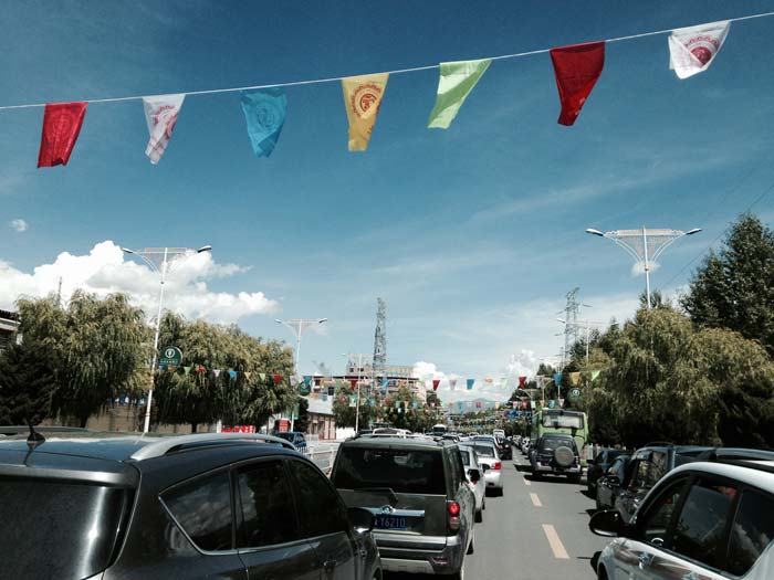 On road in bustling city of Lhasa. Apart from other vehicles, cycles and rickshaws are also a common sight.