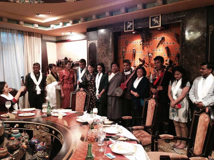 Traditional Tibetan Singers Welcome Guests at Dinner. Dressed in traditional Tibetan dresses, they sing a different song for each guest while playing Tibetan string instruments.