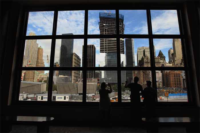 People look out from the World Financial Centre as construction of the 9/11 attacks memorial continues in New York City. (AFP Photo)