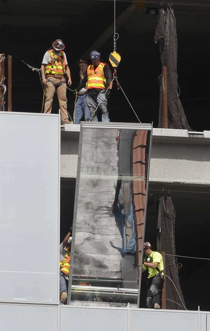 Workers install a window on Four World Trade Centre. The tower, designed by Fumihiko Maki, will be 72 floors high and is expected to open in 2013. Sunday will mark the 10th anniversary of the September 11, 2001 attacks. (AP Photo)