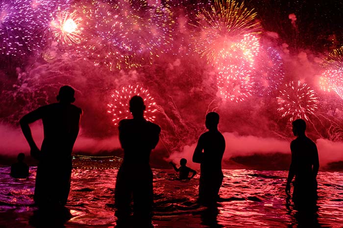 People watch fireworks during New Years celebrations at Copacabana beach in Rio de Janeiro on January 1. (AFP Photo)