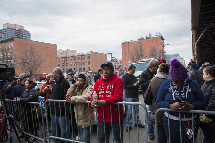 Residents gather to watch the scene of explosion. The two collapsed buildings were five stories. They were about 55 feet tall, according to Buildings Department records.